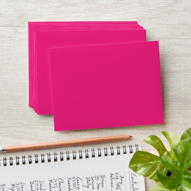 a pink background with a black envelope (Stacked)