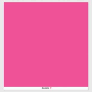 a pink background with a black sticker