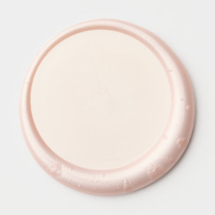 a pink background with a wax seal sticker