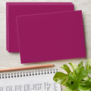a pink background with a white border envelope