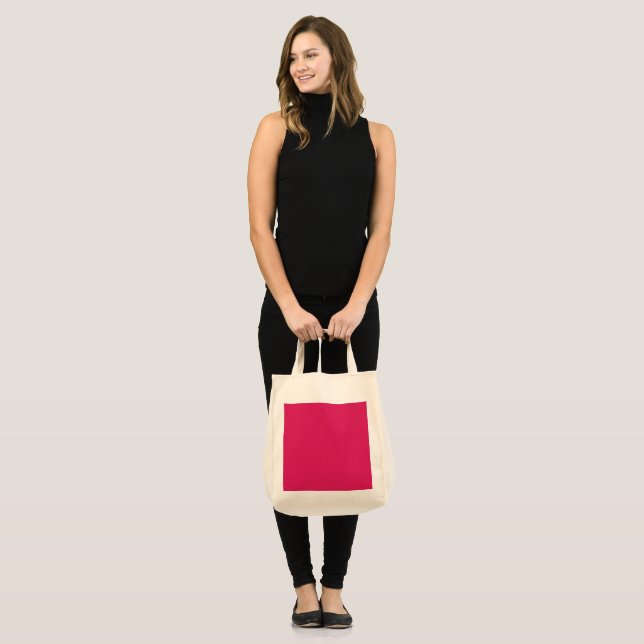 a pink background with a white border tote bag (Front (Model))