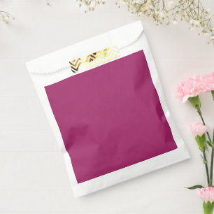 a pink background with a white favor bag
