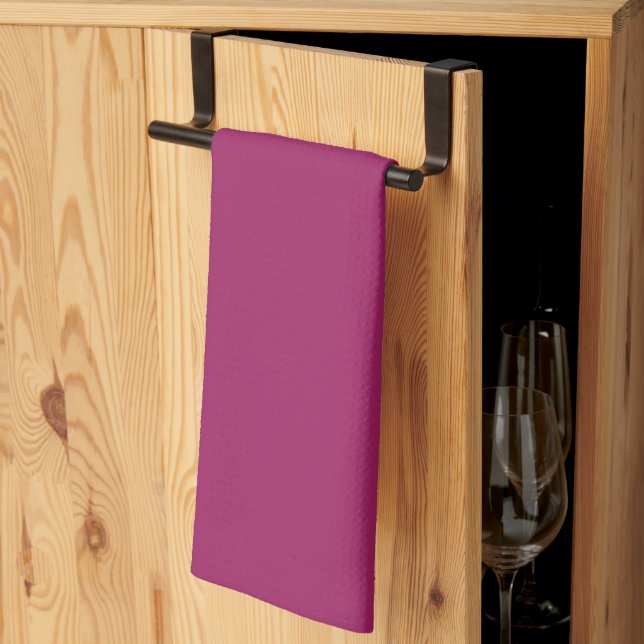 a pink background with a white kitchen towel (Thirds Fold)