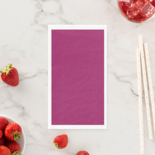 a pink background with a white paper guest towels