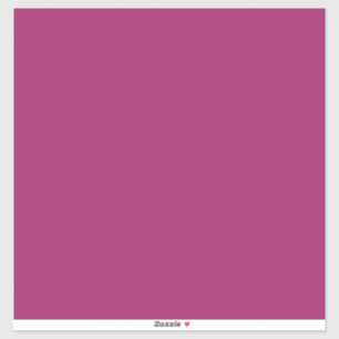 a pink background with a white sticker