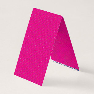 a pink background with white polka dots business card