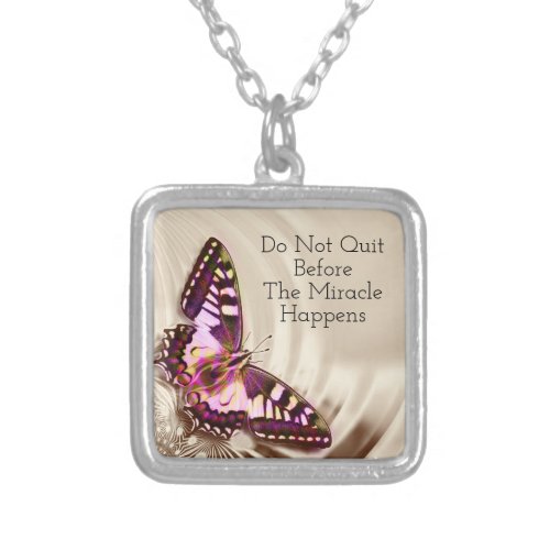 A pink butterfly on a cream satin background silver plated necklace