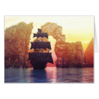 A pirate ship off an island at a sunset card