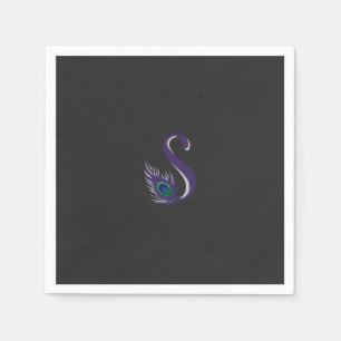 a purple and green peacock feather on a black back napkins