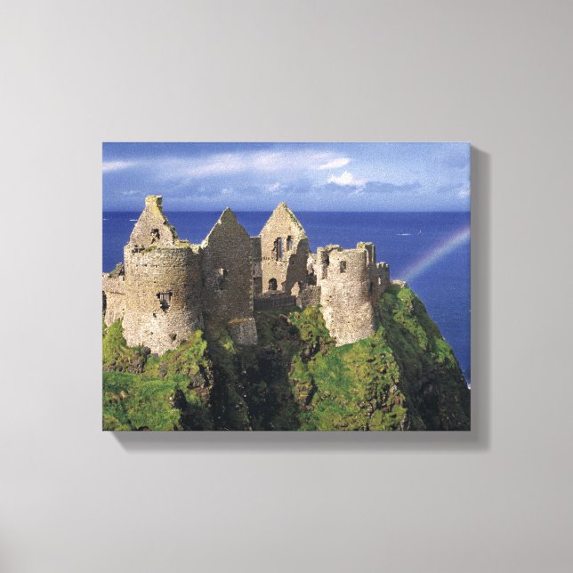 A rainbow strikes medieval Dunluce Castle on Canvas Print (Front)