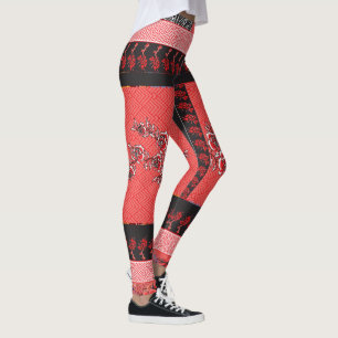 a red and black pattern with flowers on it leggings
