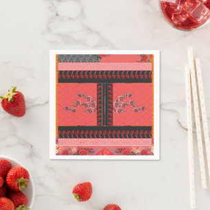 a red and black pattern with flowers on it napkins