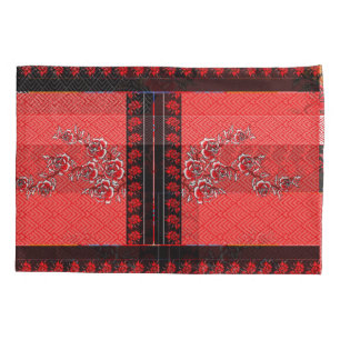 a red and black pattern with flowers on it pillow case