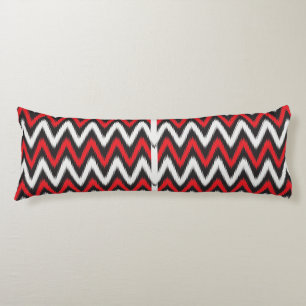 a red and black zigzag pattern on a white backgrou body pillow