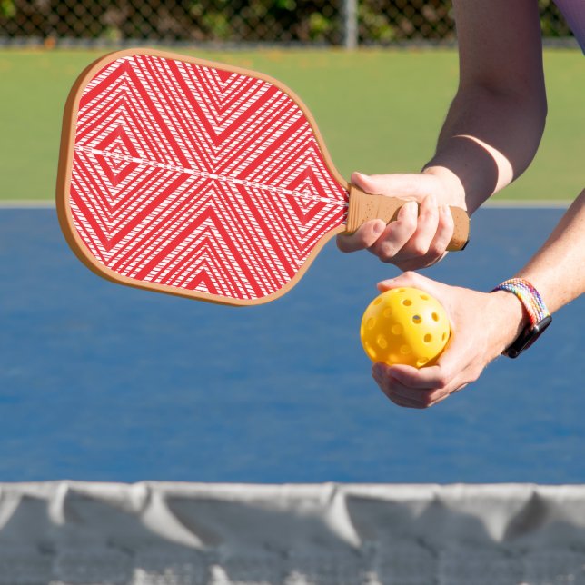 a red and white background with a diamond pattern carbon fiber pickleball paddle  (Insitu)