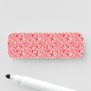a red and white background with a pattern name tag