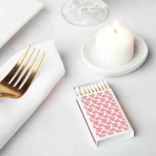 a red and white flower pattern on a white backgrou matchboxes