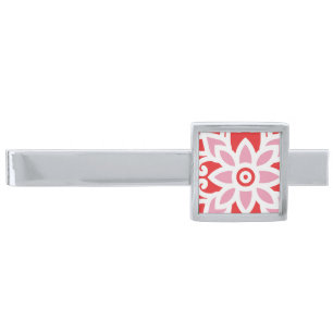 a red and white pattern with a flower on it silver finish tie bar