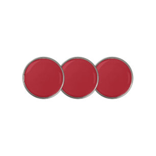 a red background with a golf ball marker