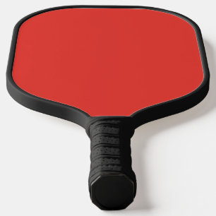a red background with a white border pickleball paddle