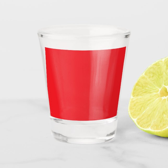 a red background with a white border shot glass (Front)