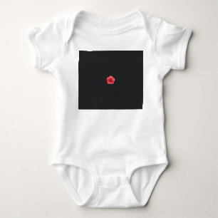 a red flower with a black center on a black backgr baby bodysuit