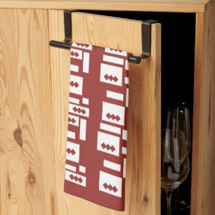 A red rug with a textured pattern is spread out on kitchen towel
