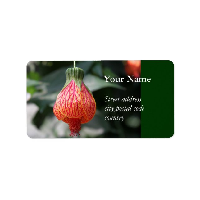 a red up-side-down hanging flower label (Front)