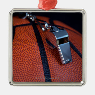 A referee's whistle rests on top of a metal ornament
