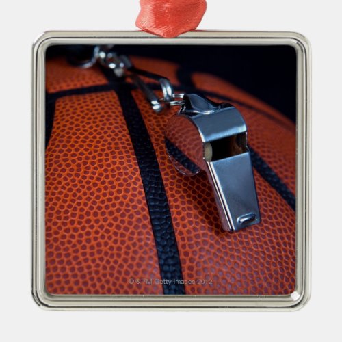 A referees whistle rests on top of a metal ornament