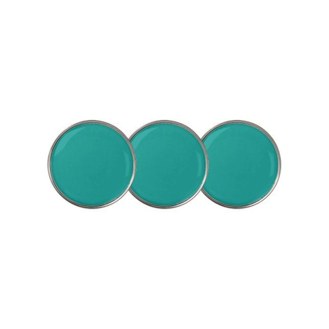 A rich teal green area highlighted by a contrastin golf ball marker (3 Up)