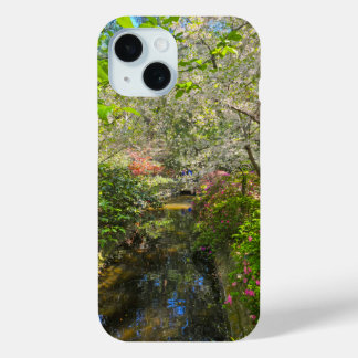 a river in the garden surrounded by flowers iPhone 15 case
