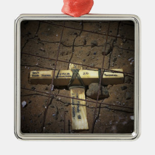 A road repair crew places a cross metal ornament