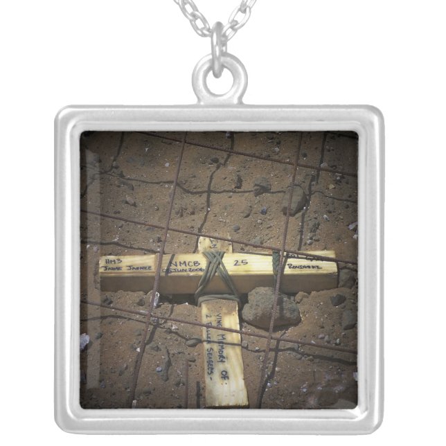 A road repair crew places a cross silver plated necklace (Front)