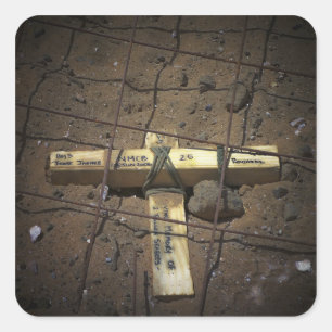 A road repair crew places a cross square sticker
