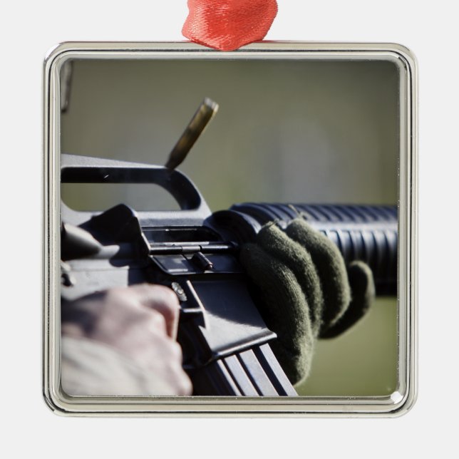 A round flies from the chamber of an M-16A2 Metal Ornament (Front)