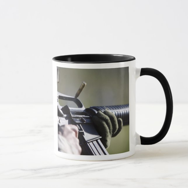 A round flies from the chamber of an M-16A2 Mug (Right)