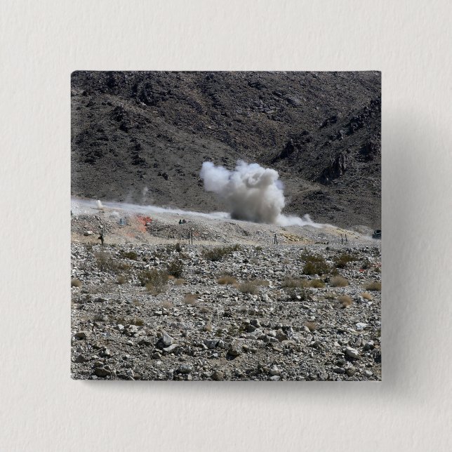 A round from an AT-4 small rocket launcher Button (Front)