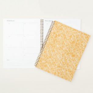 A round rug with a vibrant blend of yellow and ora planner