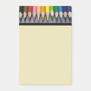 A Row of Colored Pencils. Post-it Notes