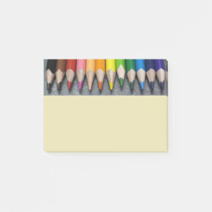 A Row of Colored Pencils. Post-it Notes