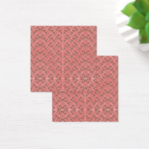 A rug with a red and pink motif features a decorat