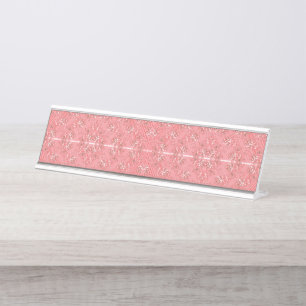 A rug with a red and pink motif features a decorat desk name plate