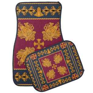 A scarf with a pattern of gold heads of lions and car floor mat