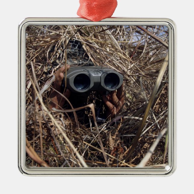 A scout observer practices observation techniqu 2 metal ornament (Front)