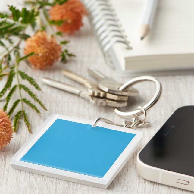 A serene blue sky with a few scattered white cloud keychain (Front Right)