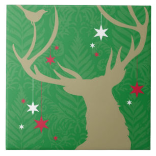 A silhouette of a deer with stars hanging from its ceramic tile