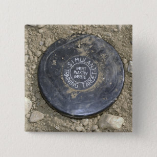 A simulated land mine button