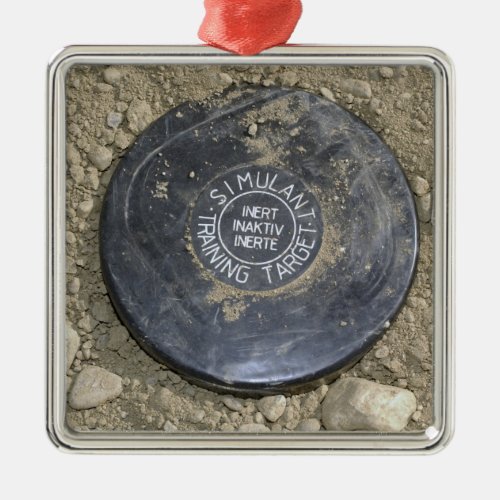 A simulated land mine metal ornament