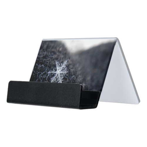 A single snowflake on stands out desk business card holder